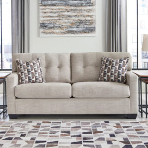 Light beige full sofa sleeper with tufted back cushions and modern accent pillows