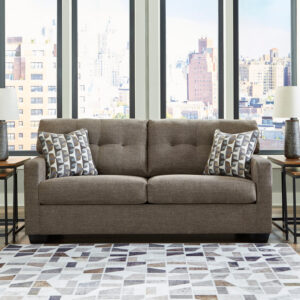 Brown full sofa sleeper with tufted back cushions and patterned accent pillows