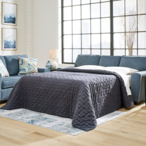 Blue queen sofa sleeper with accent pillows in a modern living room setting