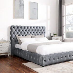 Gray tufted upholstered bed frame with deep diamond tufting in modern luxury bedroom