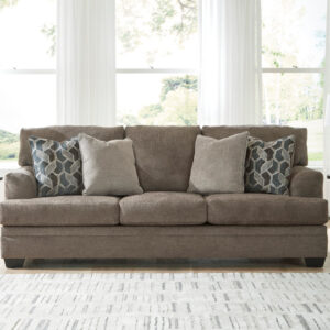 Dark brown queen sleeper sofa with accent pillows in a modern living room