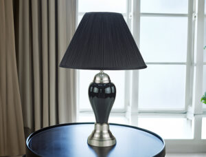 Black porcelain table lamp with black shade on round table