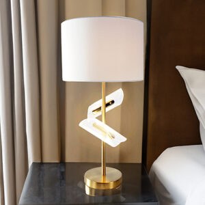 Modern sculptural table lamp with gold base and white shade