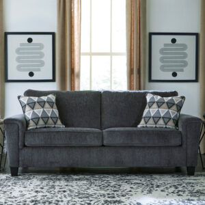 Charcoal gray queen sleeper sofa with geometric accent pillows in a modern living room