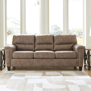 Taupe queen sleeper sofa with plush cushions and soft upholstery in a bright living room